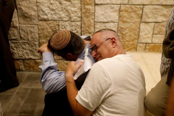 The brothers of Ari Fuld, 45, an American-born Jewish settler fatally stabbed by a Palestinian, mourn during his funeral at a cemetery in Kfar Etzion in the occupied West Bank September 16, 2018. 