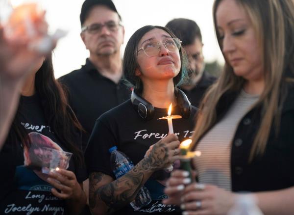 Jocelyn's mother Alexis Nungaray holding a candle at a vigil for her daughter on June 21, 2024.