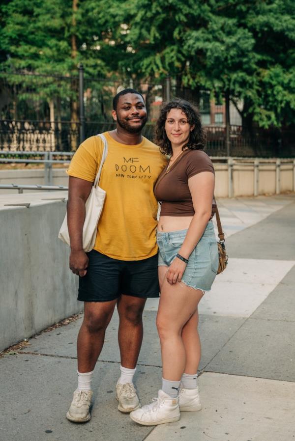 Malik Schroeder and Jewel Moore, young couple who met on Tinder, posing for a photograph on a Manhattan sidewalk