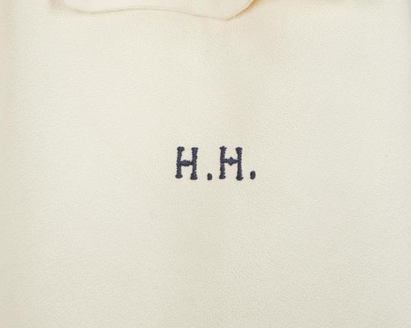 A photo of Hughes' initials, H.H. embroidered on the front.