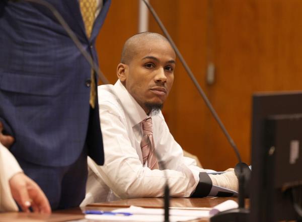 Rivera stares from the defendant's table in a Queens courtroom.