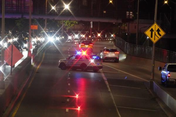 Police investigate the scene wher<em></em>e a woman was fatally struck by a vehicle by a black sedan that left the scene on the northbound FDR Drive at East Houston Street.