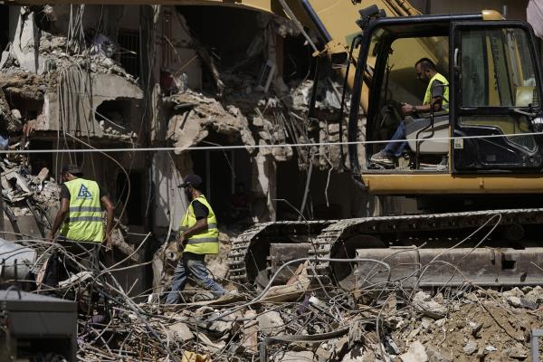 Emergency workers clear the rubble at the site of Friday's Israeli strike in Beirut's southern suburb, Sunday, Sept. 22, 2024. (AP Photo/Bilal Hussein)