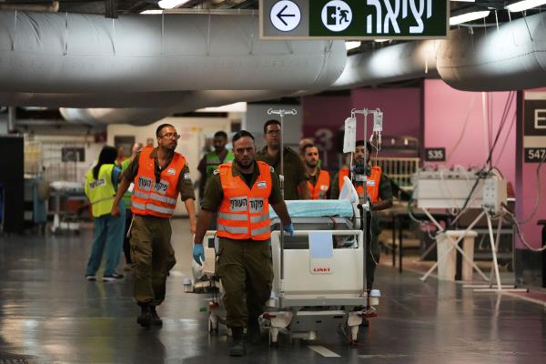 Hospital staff and soldiers move patients and equipment to the underground ward at Rambam medical center as fighting escalates between Israel and the Lebanese militant group Hezbollah. in Haifa, Israel, on Sunday, Sept. 22, 2024. (AP Photo/Ohad Zwigenberg)